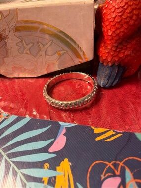 silver-tone bangle bracelet featuring rows of clear rhinest